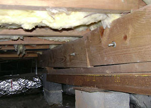 sagging crawl space with wooden shimming a Romulus crawl space