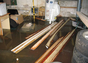 A severely flooding basement in Williamson, with lumber and personal items floating in a foot of water