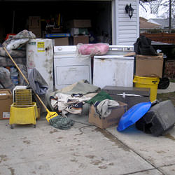 Soaked, wet personal items sitting in a driveway, including a washer and dryer in Newark.